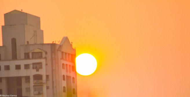 Sunset behind a building
